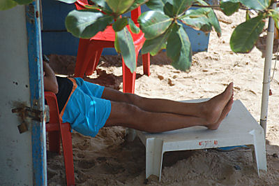 One of the guys sitting waiting for the tourists to sit down