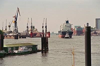 A big container-ship is going to the quey